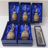 Five Sterling Classic pewter bottle-stoppers on barrel stands and a bottle-opener. All in