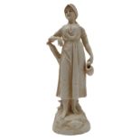 A German Rudolstadt porcelain female figure: she carries a jug in her left hand and her right