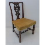 An 18th century style (later) single mahogany salon chair: the top rail carved with acanthus in