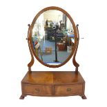 A reproduction bow-fronted mahogany toilet mirror: oval plate and two half-width drawers, raised