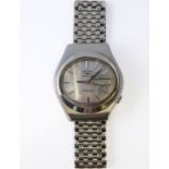 A gentleman's vintage steel-cased wristwatch with integral steel strap: the silver-coloured dial