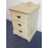 A three-drawer shabby-chic-style bedside chest with galleried back (51.5 cm wide x 47.5 cm deep x 73