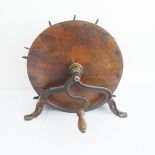 A 19th century oak and iron mounted circular knife cleaner with varying sized apertures and manual