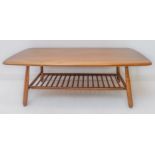 A good Ercol elm coffee table: figured top above four turned splayed legs united by a ladder-style