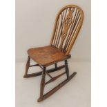 A 19th century ash and elm seated wheelback rocking chair of good colour