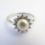 An 18-carat white gold, pearl and diamond cluster ring, size M