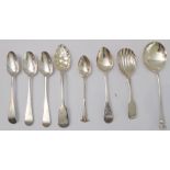 Four hallmarked silver teaspoons and four others to include a caddy spoon with shell-shaped bowl,