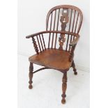 An unusual mid 19th century child's comb back Windsor armchair: yew wood bow and splat, shaped elm