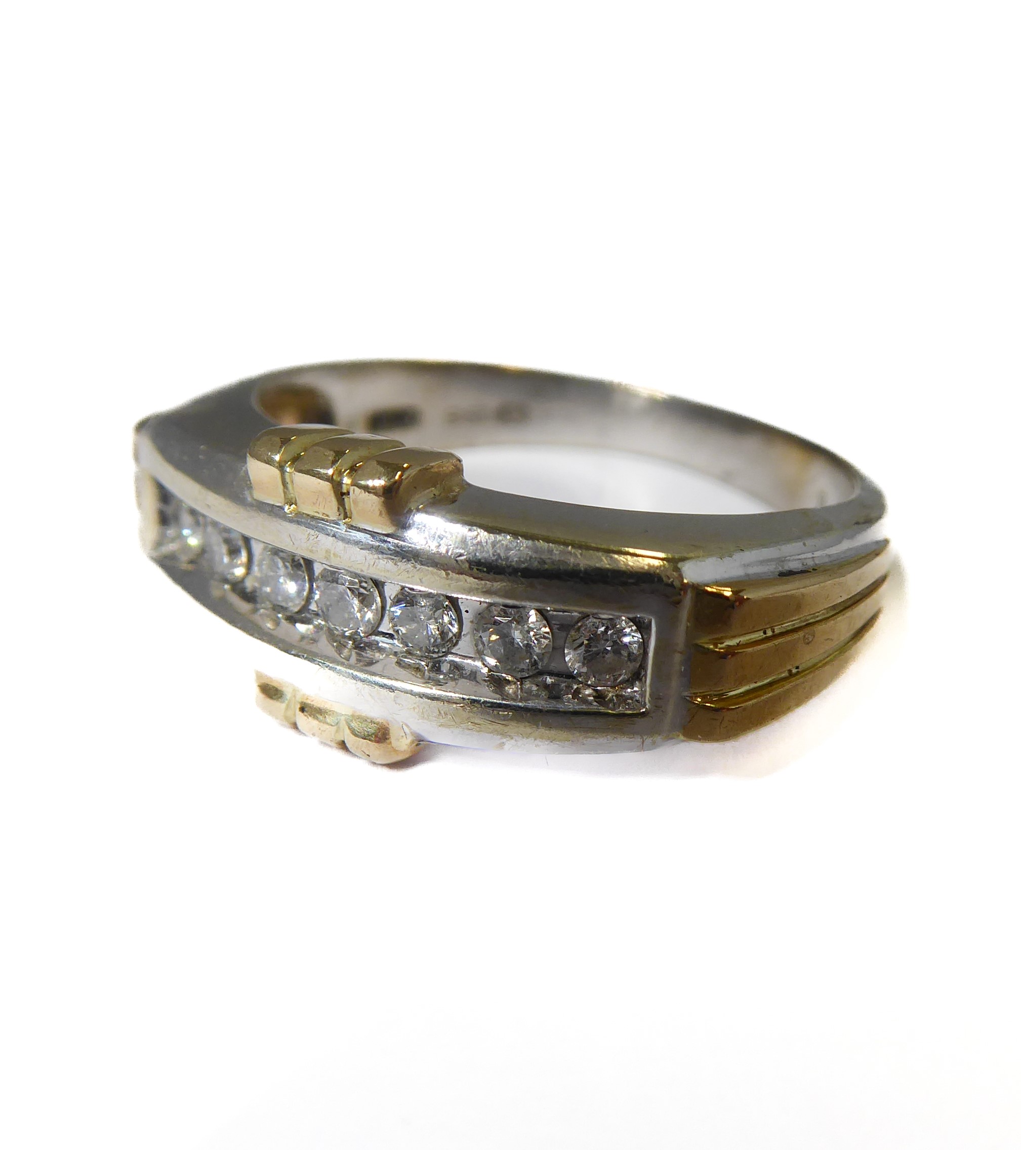 A 9-carat gold ring set with seven diamonds, ring size T