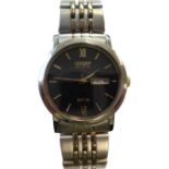 A Citizen Eco Drive steel-cased wristwatch with integral steel and gold-plated strap; the black dial
