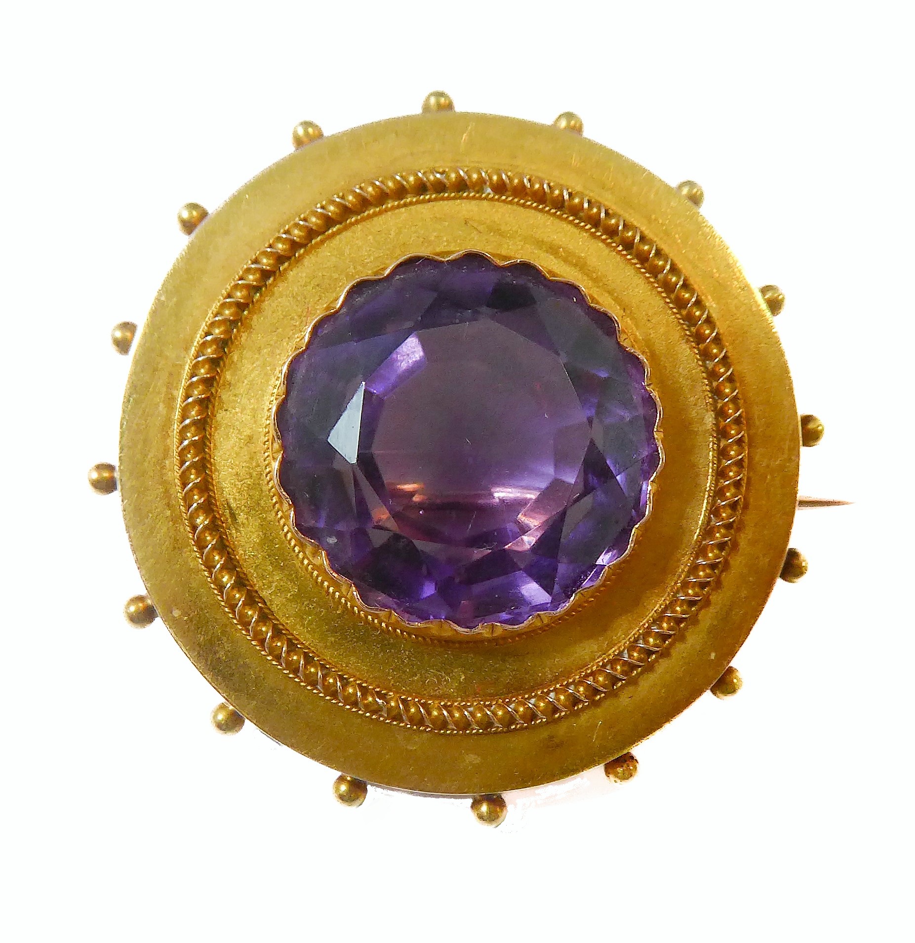 A mid-19th century amethyst and yellow-gold brooch: the central circular mixed-cut amethyst collet-