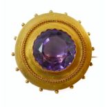 A mid-19th century amethyst and yellow-gold brooch: the central circular mixed-cut amethyst collet-