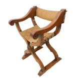 An oak Savonarola-style chair (probably early 20th century): the original oxblood leather cover with