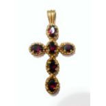 A 9-carat yellow gold cross mounted with six hand-cut oval garnets below an oval bale suspension