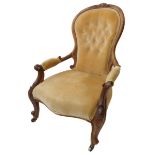 A 19th century walnut spoon-back upholstered open armchair: scrolling arm terminals and moulded