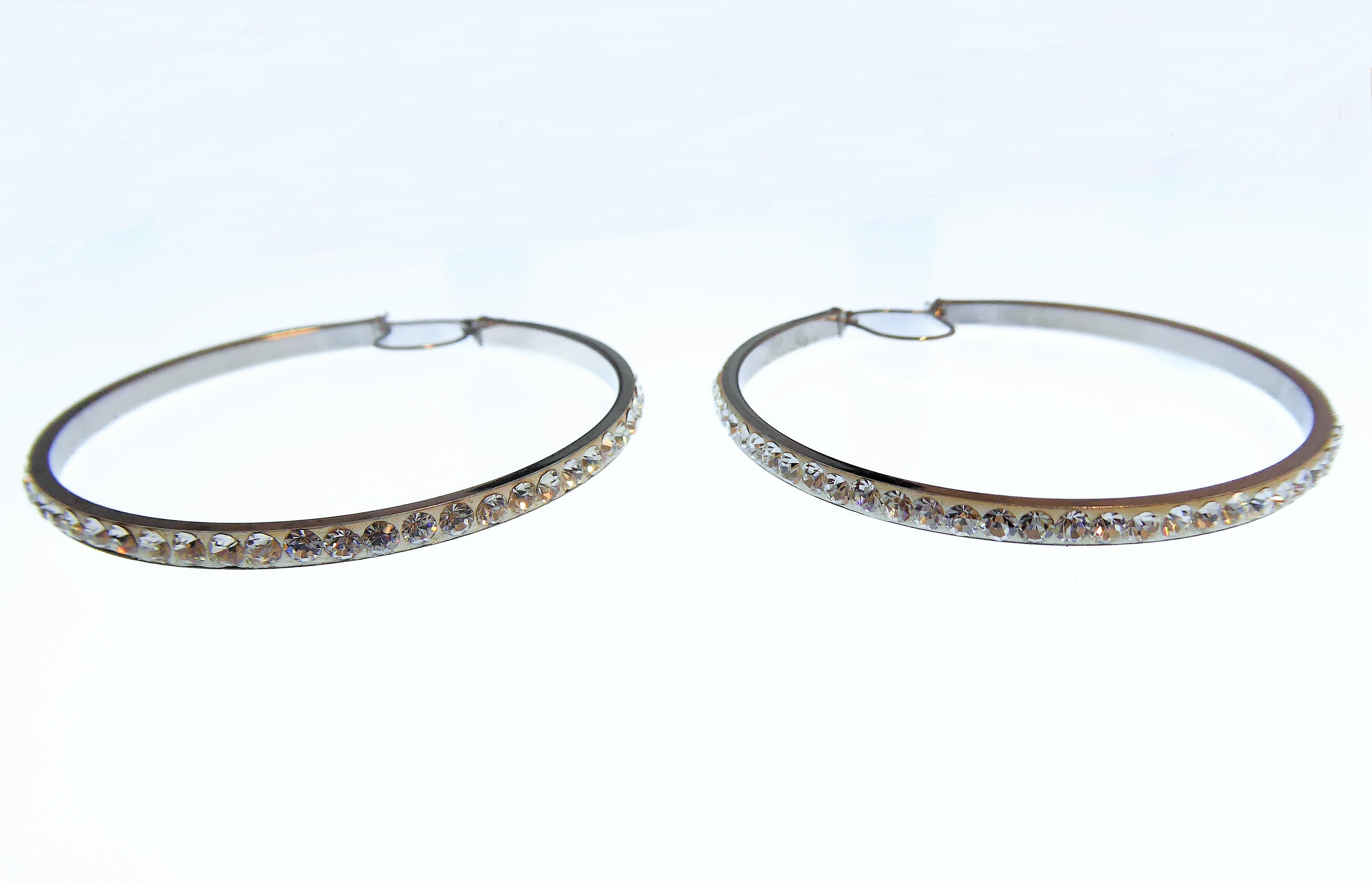 A large pair of circular silver hoop earrings set with white stones (boxed)