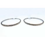 A large pair of circular silver hoop earrings set with white stones (boxed)