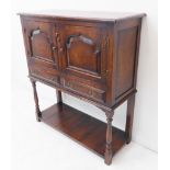 A good reproduction solid oak side cabinet: slightly overhanging top above two fielded panelled door