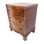 A reproduction three-drawer serpentine-fronted walnut chest, three full-width graduated drawers,