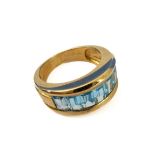 A 9-carat gold emerald-cut channel set blue topaz ring, size J/K