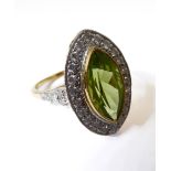 An 18-carat gold marquise-shaped ring set with a marquise peridot and diamond cluster, ring size N