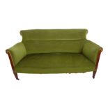 An early 20th century green-velour-upholstered sofa: show-wood mahogany front legs with boxwood