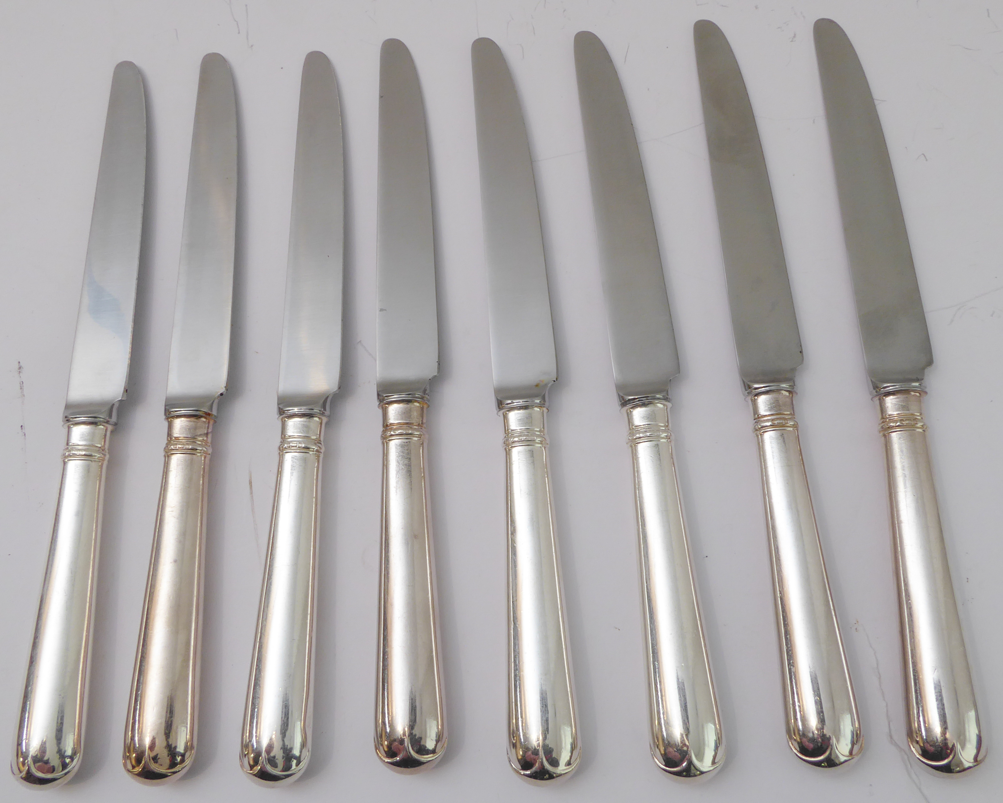 A set of eight large table-knives with hallmarked silver handles and steel blades (24.75cm long)