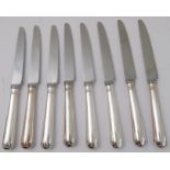 A set of eight large table-knives with hallmarked silver handles and steel blades (24.75cm long)
