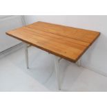A mid-20th century pine breakfast-style table having turned angular tapering white-painted legs