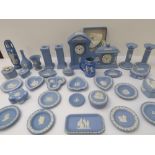 A large collection of 20th century Wedgwood pale-blue Jasperware to include: two mantle clocks; a