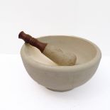 A large early 20th century ceramic pestle and mortar: the pestle with two-toned turned wooden