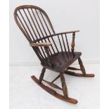 A 19th century comb-back Windsor rocking chair with ash bow shaped elm seat and rockers