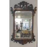 An 18th century style (probably 19th century) mahogany and parcel-gilt framed looking glass: the