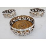 Three 19th century silver-plated wine-bottle coasters: each with pierced central band with