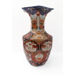 A large 19th century Japanese porcelain vase of hexagonal baluster form; the flaring rim with