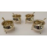 A set of four George V silver salts with matching salt spoons, Chester 1912. The cauldron-shaped