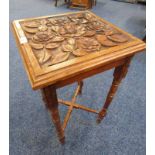 LATE 19TH CENTURY MAHOGANY TABLE WITH CARVED TOP ON TURNED SUPPORTS,