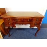 WALNUT DESK WITH LEATHER INSET SERPENTINE TOP WITH SINGLE DRAWER FLANKED BY 2 SHORT DRAWERS TO EACH