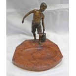 EARLY 20TH CENTURY METAL FIGURE OF A BOY CARRYING A PAIL OF WATER ON A HARDSTONE BASE,