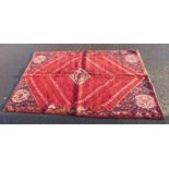 RED GROUND WOVEN PERSIAN QASHQI TRIBAL RUG WITH UNIQUE MEDALLION DESIGN,