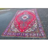 LARGE RED GROUND PERSIAN TABRIZ CARPET WITH VIBRANT COLOURS WITH A FLORAL MEDALLION PATTERN,