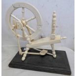 19TH CENTURY IVORY MODEL OF A SPINNING WHEEL ON A LATER WOODEN BASE