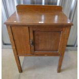 LATE 19TH CENTURY OAK COMMODE CABINET WITH SINGLE PANEL DOOR ON SQUARE SUPPORTS