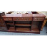 20TH CENTURY MAHOGANY LOW OPEN BOOKCASE WITH 3 DRAWERS ON PLINTH BASE.