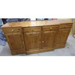 DUCAL PINE BREAKFRONT SIDEBOARD OF 4 DRAWERS OVER 4 PANEL DOORS.