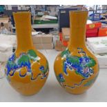 PAIR OF 19TH CENTURY CHINESE MUSTARD GLAZED POTTERY BOTTLE NECK VASES DECORATED WITH DRAGONS - 43