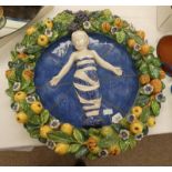 19TH CENTURY MAJOLICA PLAQUE DEPICTING A CHILD SURROUNDED BY FRUIT AND FLOWERS ATTRIBUTED TO DELIA