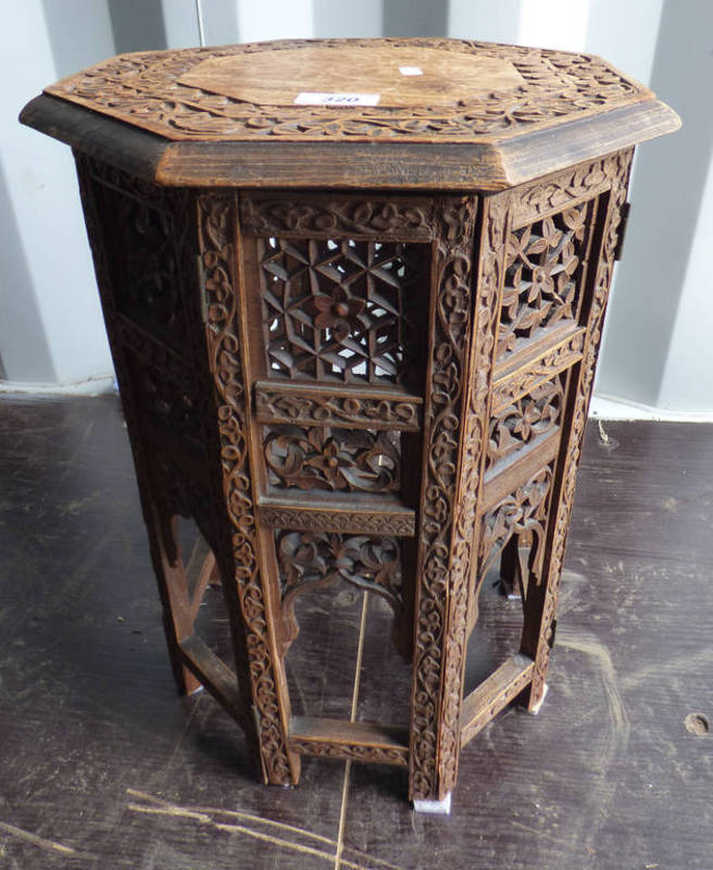 EASTERN HARDWOOD OCTAGONAL TABLE WITH DECORATIVE ORIENTAL CARVING,