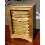HARDWOOD TABLE TOP FILING CHEST OF 11 DRAWERS BEHIND GLASS PANEL DOOR,