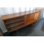 TEAK BOOKCASE WITH ADJUSTABLE SHELVES AND 2 SLIDING GLASS PANEL DOORS ON SQUARE SUPPORTS LENGTH